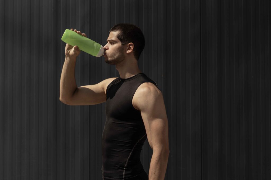 portrait-muscular-man-taking-break-hydrate-his-body-after-training_11zon